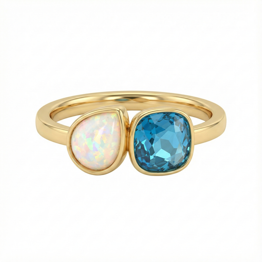 Bague dorée or 18k avec pierre bleue facettée et opale blanche, design asymétrique lumineux et élégant