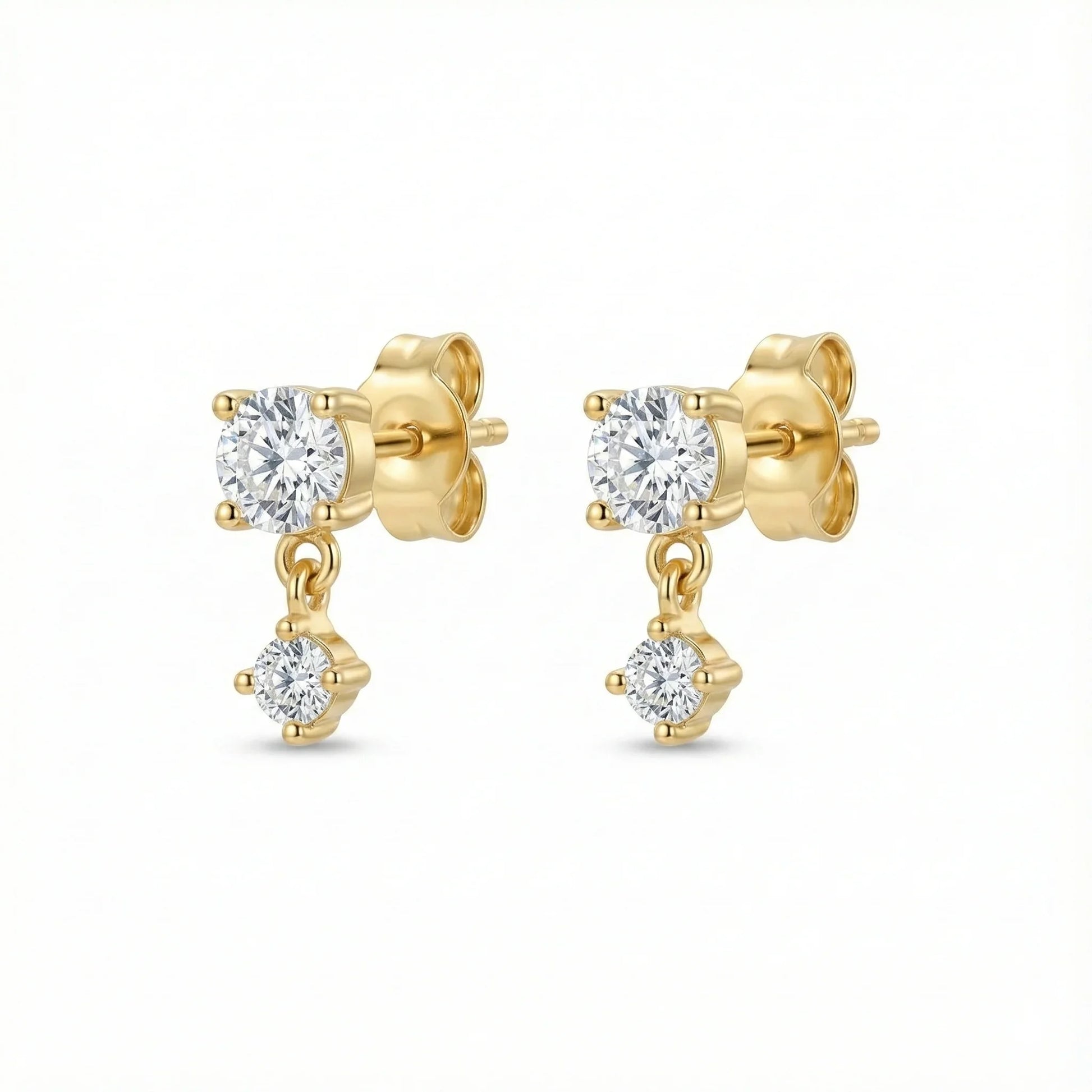 Puces d'oreilles dorées composées d'un solitaire rond et d'un second zirconium plus petit suspendu et mobile