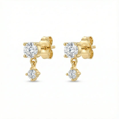 Puces d'oreilles dorées composées d'un solitaire rond et d'un second zirconium plus petit suspendu et mobile